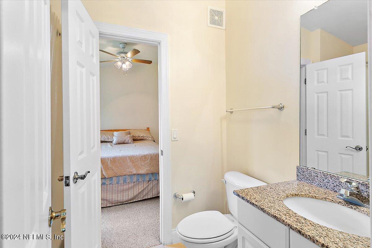 160 Legendary Drive, Unit 206 St. Augustine, FL 32092 - Photo 12 of 20 a bathroom with a granite countertop sink toilet and shower