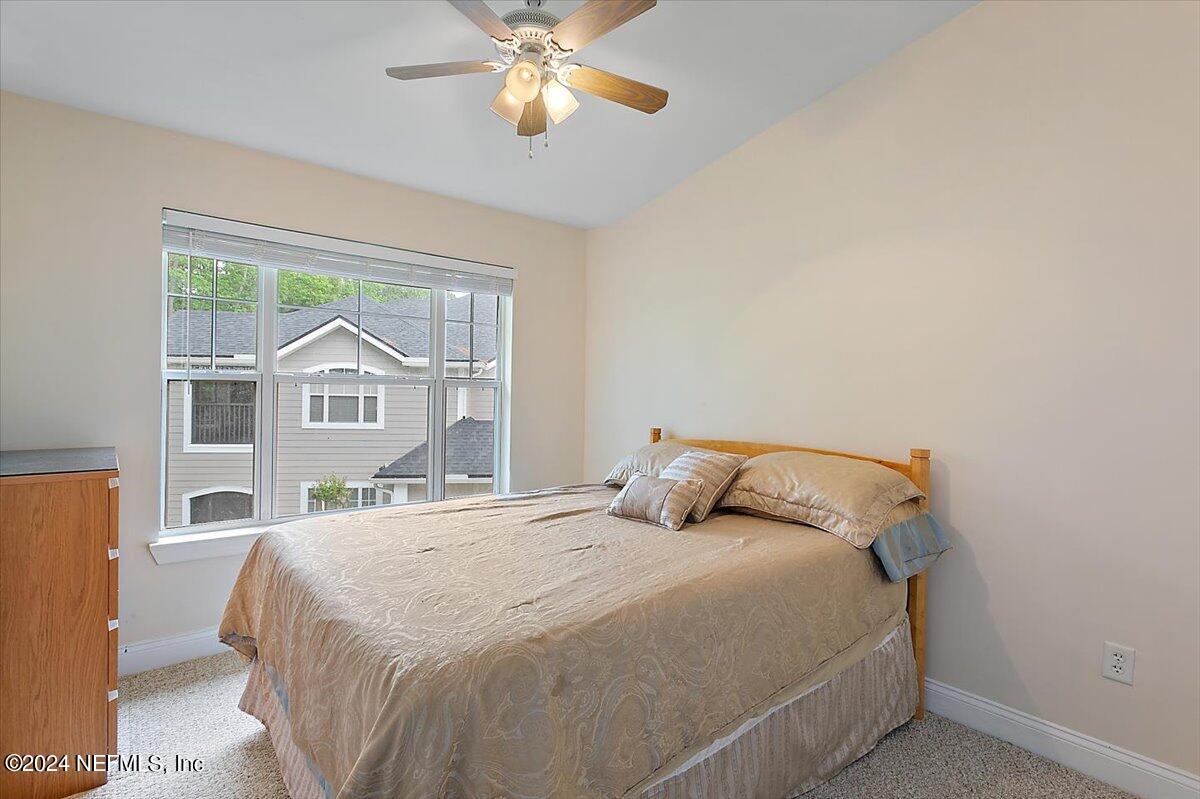 160 Legendary Drive, Unit 206 St. Augustine, FL 32092 - Photo 14 of 20 a bedroom with a bed and a large window
