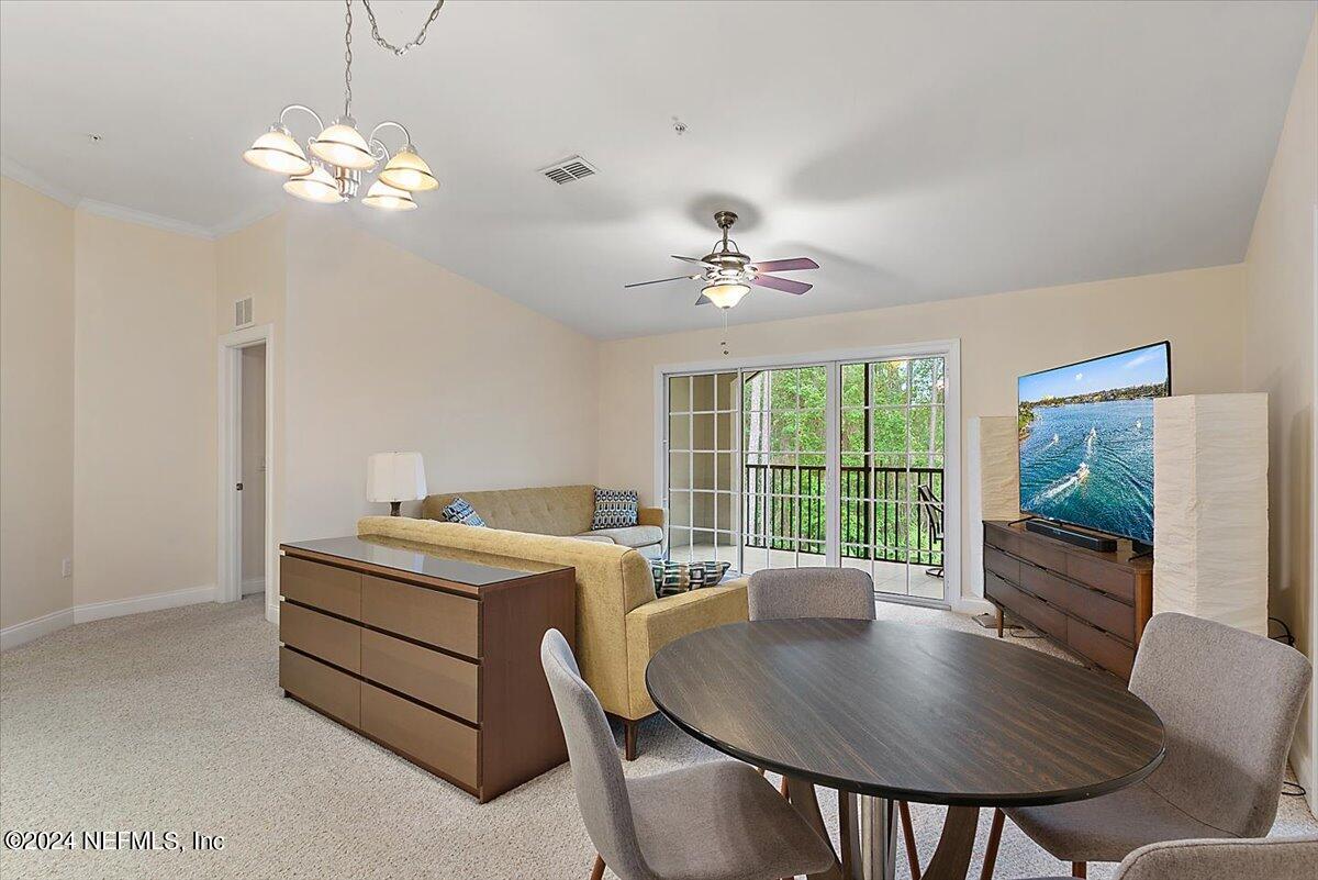 160 Legendary Drive, Unit 206 St. Augustine, FL 32092 - Photo 3 of 20 a view of a dining room with furniture a livingroom and chandelier