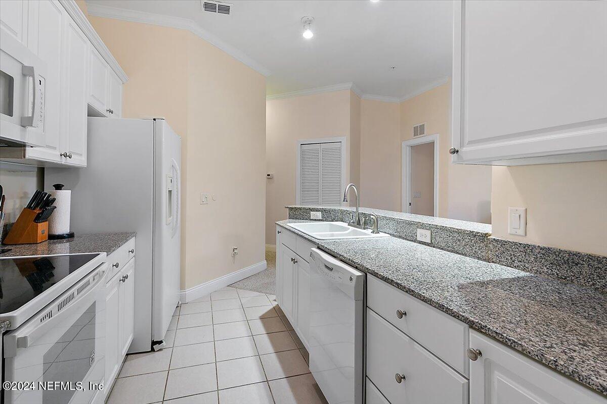 160 Legendary Drive, Unit 206 St. Augustine, FL 32092 - Photo 8 of 20 a kitchen with a sink and cabinets