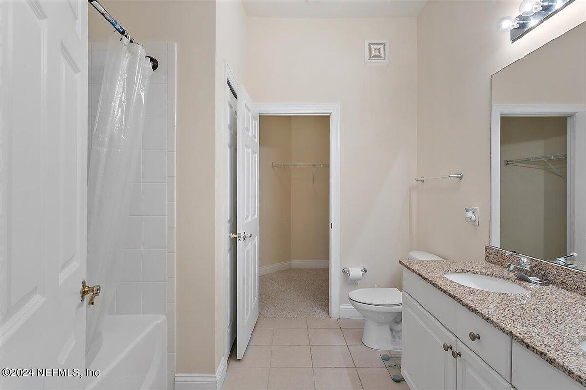 160 Legendary Drive, Unit 206 St. Augustine, FL 32092 - Photo 10 of 20 a bathroom with a granite countertop sink toilet and shower