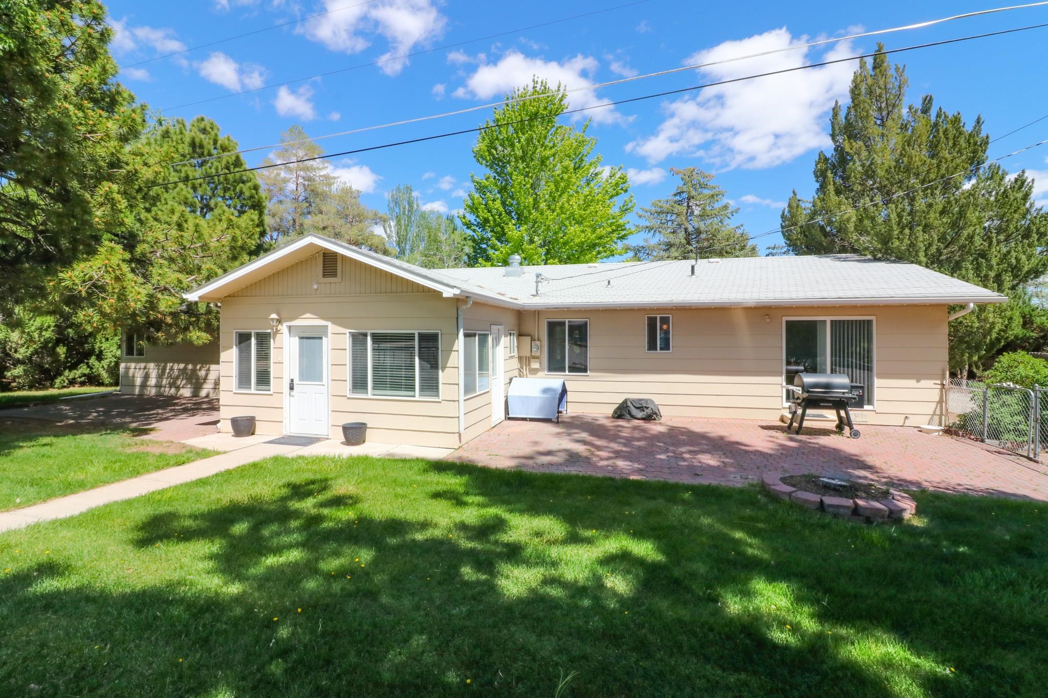 607-28 28 3/4 Road Grand Junction, CO 81506 - Photo 23 of 42 a front view of a house with a garden and patio