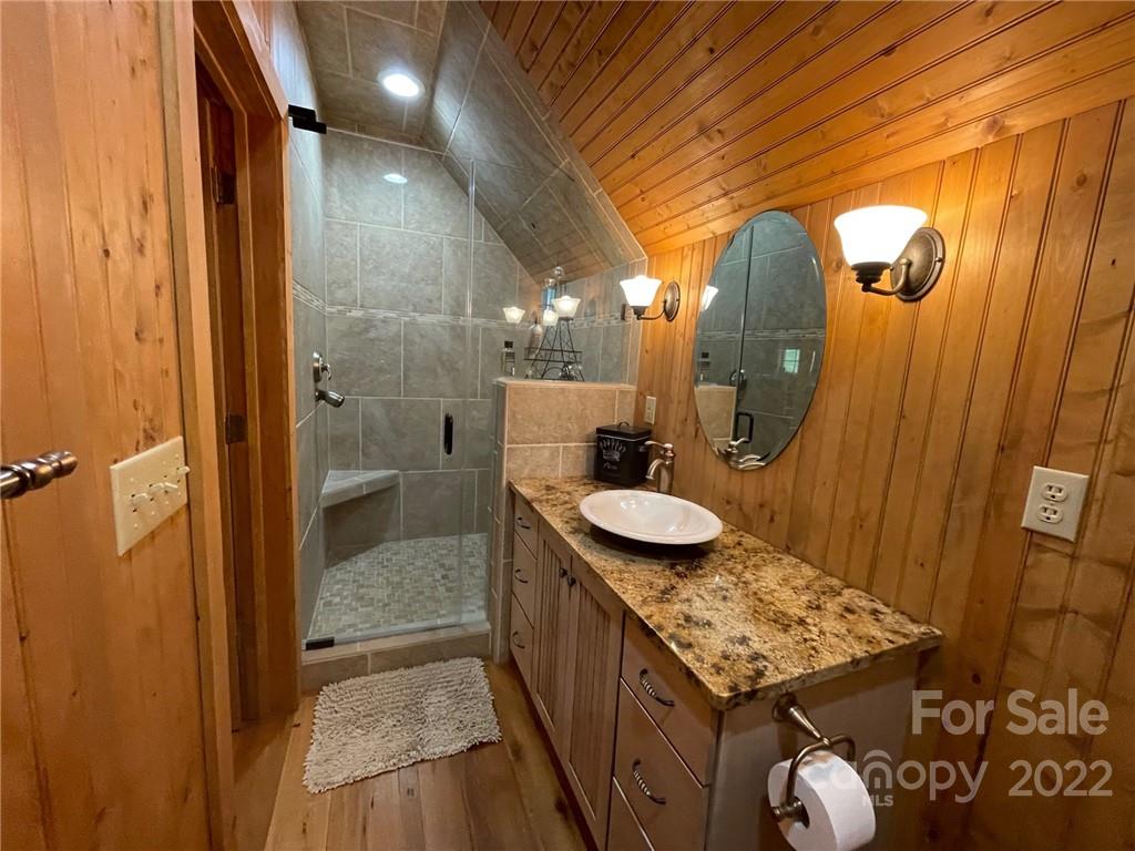 8754 Riverwood Road Terrell, NC 28682 - Photo 38 of 48 a bathroom with a granite countertop sink and a mirror
