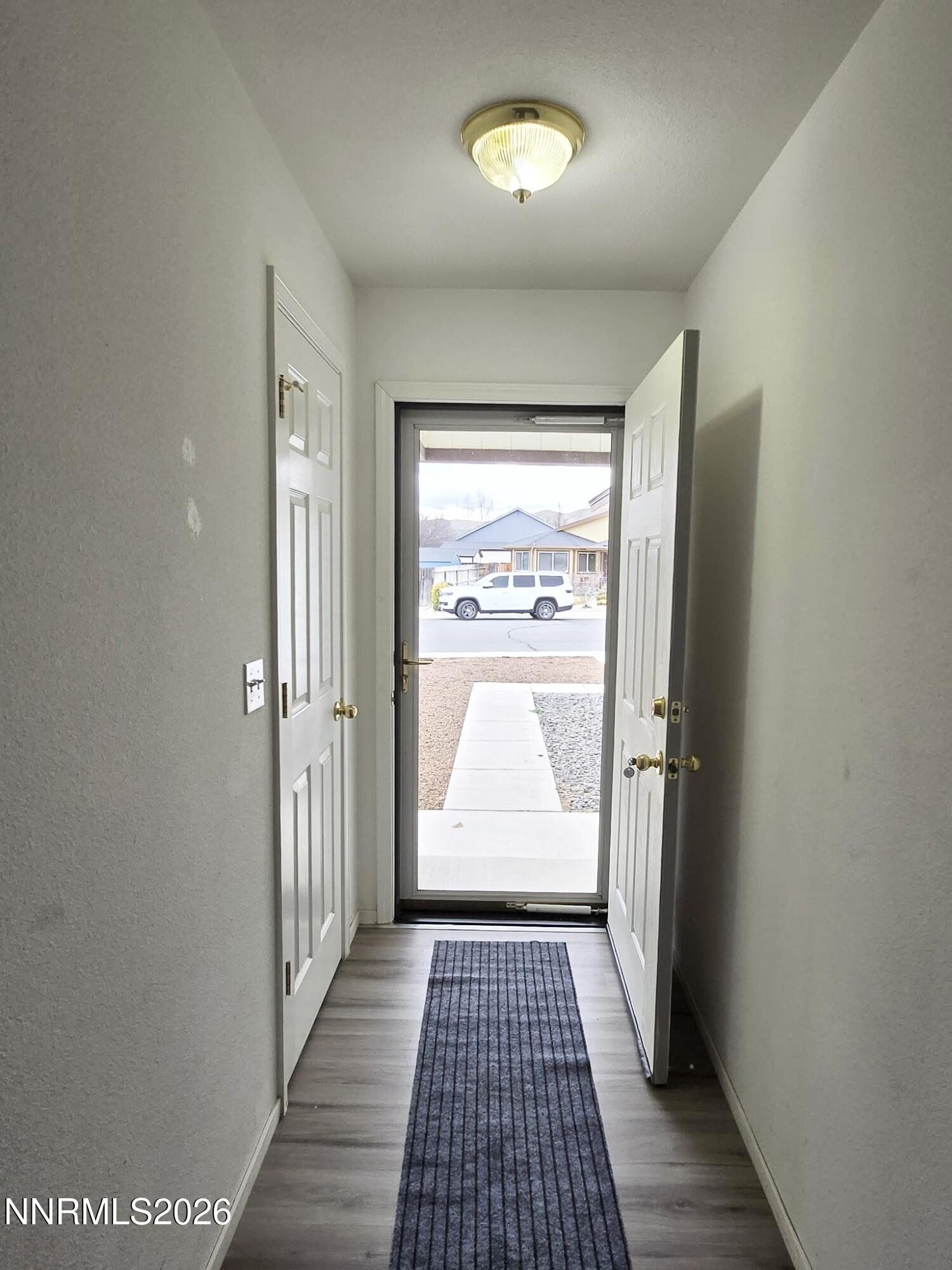 476 Jennys Lane Fernley, NV 89408 - Photo 3 of 29 an empty room with wooden floor and windows