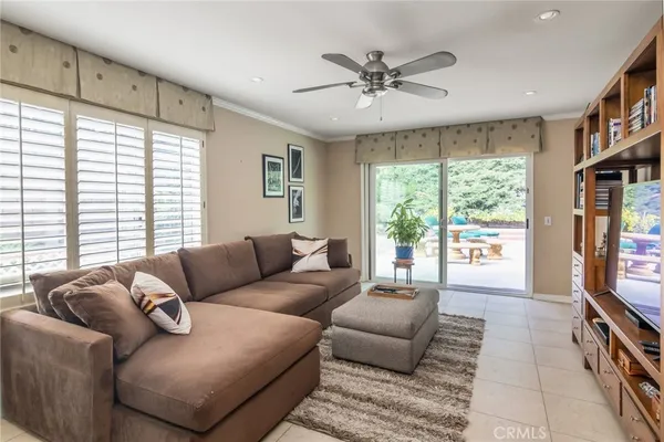 a living room with furniture and cabinets
