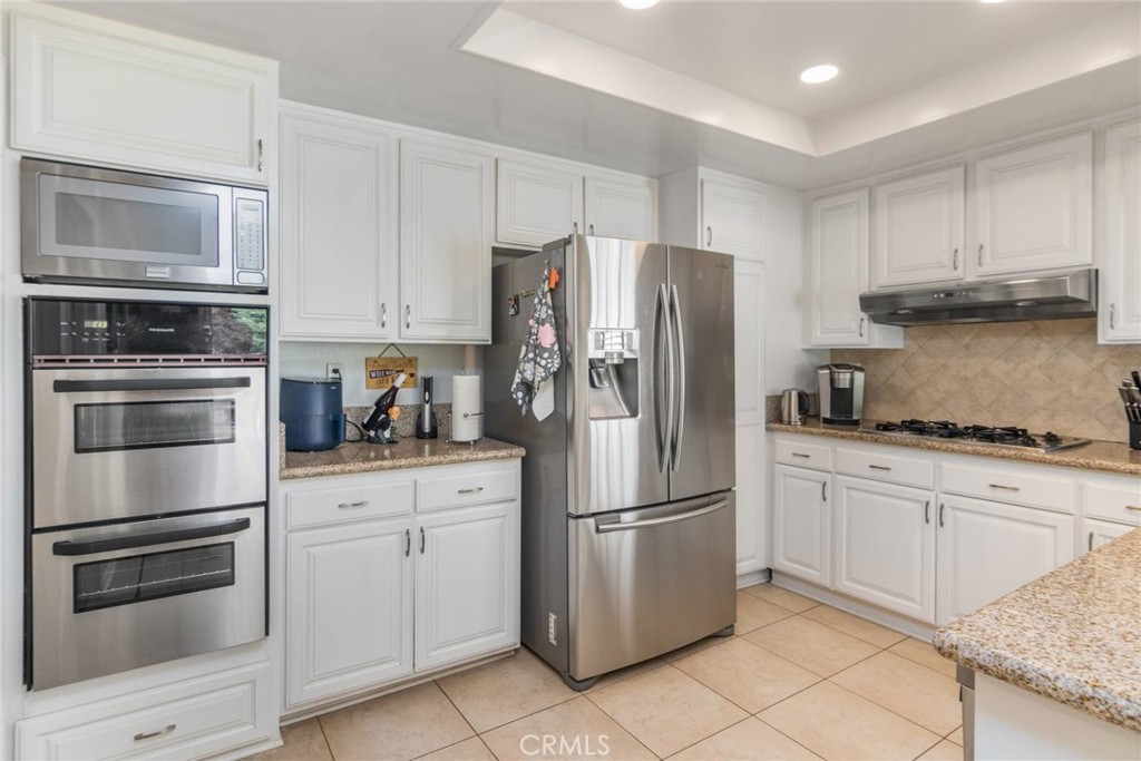 19343 Pauma Valley Drive Porter Ranch, CA 91326 - Photo 14 of 28 a kitchen with cabinets stainless steel appliances and a counter space