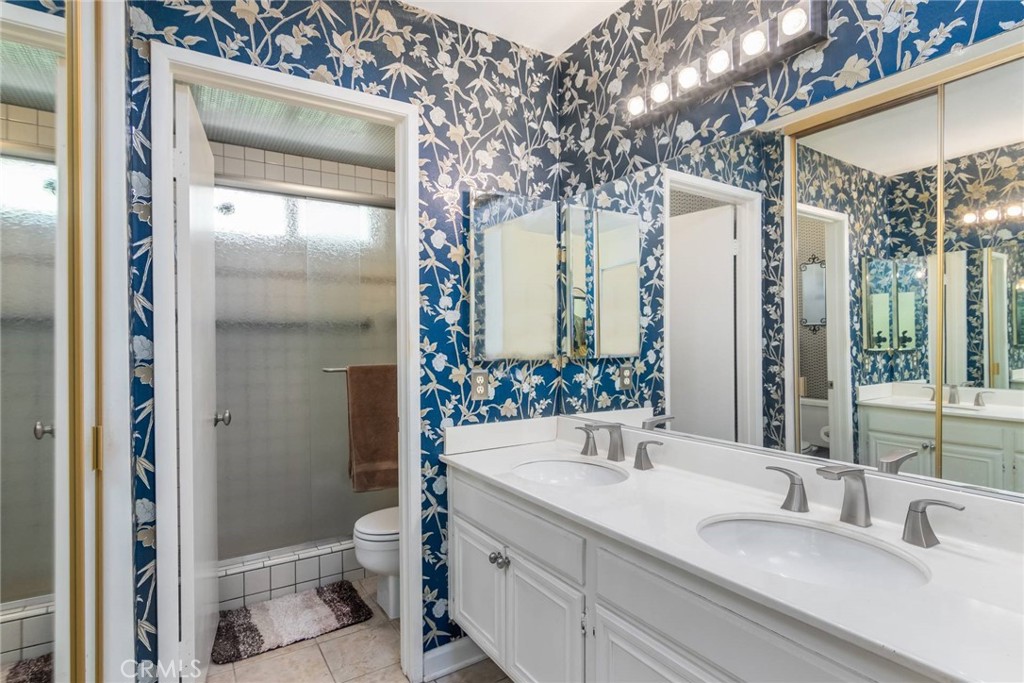 19343 Pauma Valley Drive Porter Ranch, CA 91326 - Photo 17 of 28 a bathroom with a sink and mirror with toilet
