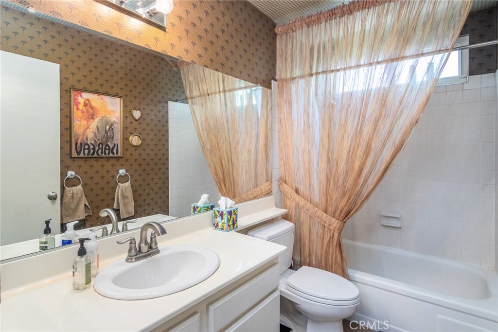 19343 Pauma Valley Drive Porter Ranch, CA 91326 - Photo 20 of 28 a bathroom with a sink toilet and shower