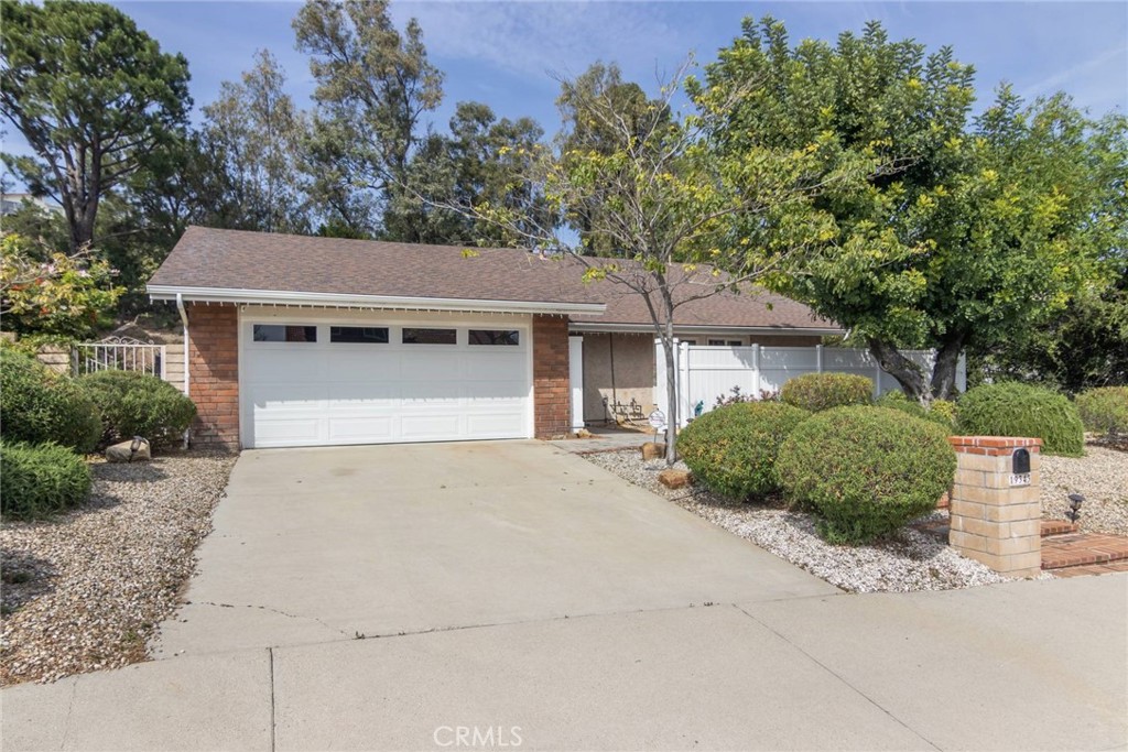 19343 Pauma Valley Drive Porter Ranch, CA 91326 - Photo 24 of 28 a front view of a house with a garden