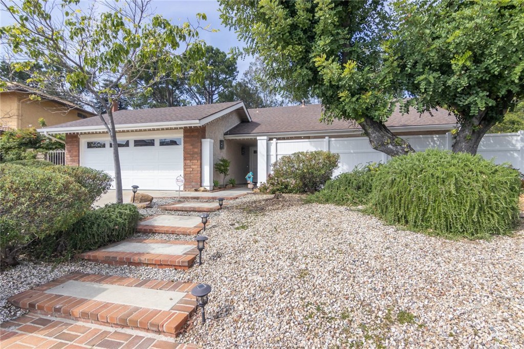 19343 Pauma Valley Drive Porter Ranch, CA 91326 - Photo 25 of 28 a front view of a house with a garden