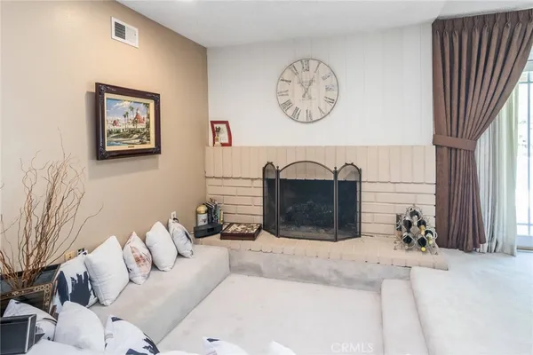 a view of a dining room with furniture a rug and wooden floor