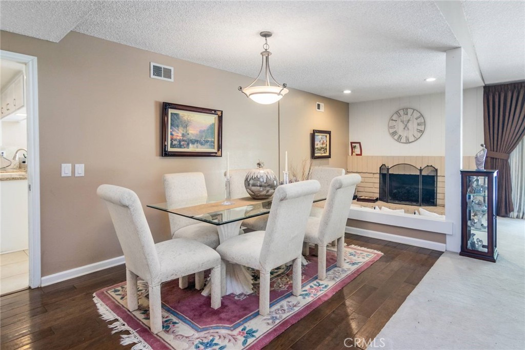 19343 Pauma Valley Drive Porter Ranch, CA 91326 - Photo 8 of 28 a view of a dining room with furniture a rug and wooden floor