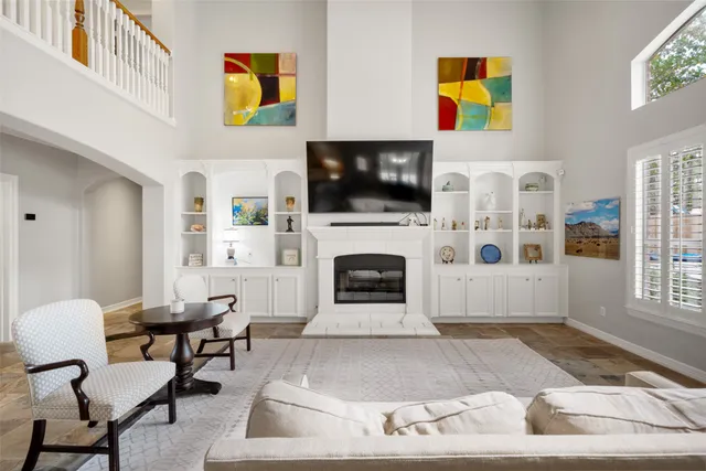a living room with furniture a flat screen tv and a fireplace