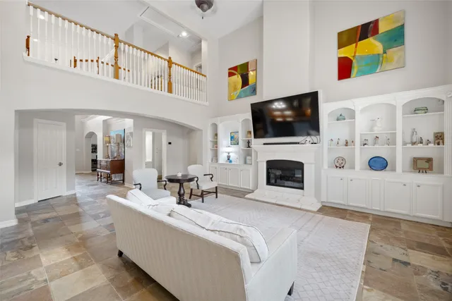 a living room with fireplace furniture a flat screen tv and a fireplace