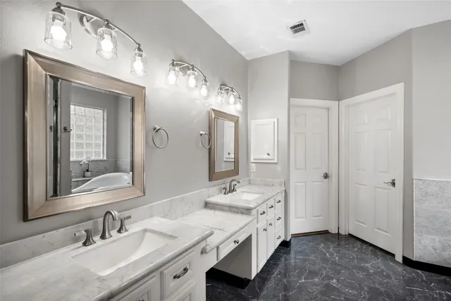 a spacious bathroom with a double vanity sink double and mirror