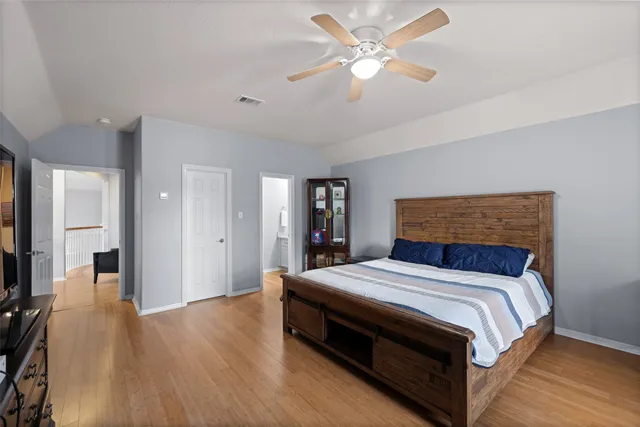 a bedroom with a bed and a chandelier