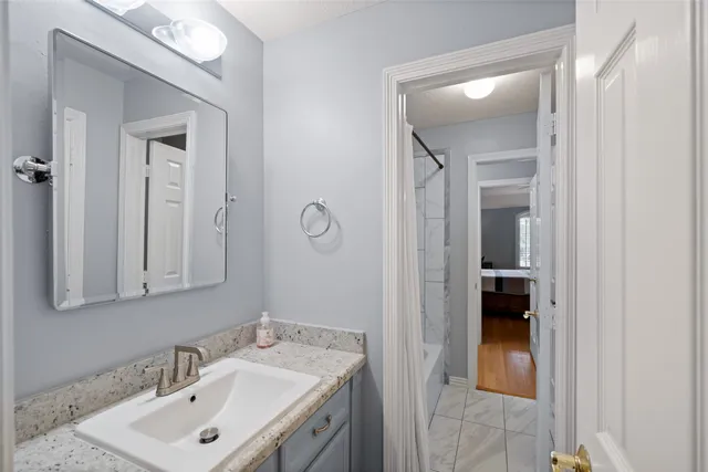 a bathroom with a sink vanity and mirror