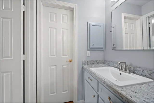 a bathroom with 2 sink and mirror