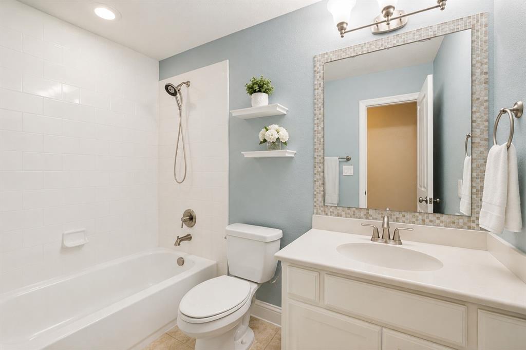 773 South Coppell Road Coppell, TX 75019 - Photo 24 of 30 a bathroom with a sink a toilet and shower