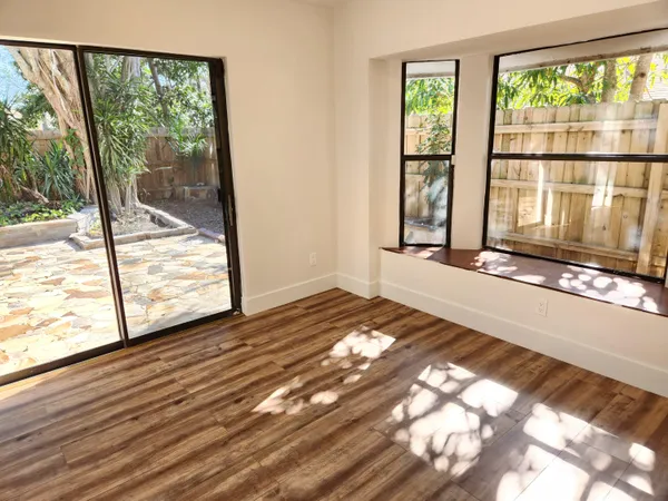 a view of a room with wooden floor and window