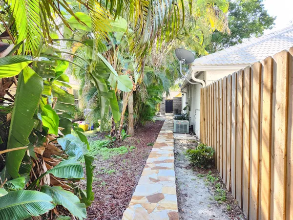 a spacious bathroom with a granite countertop sink and a mirror