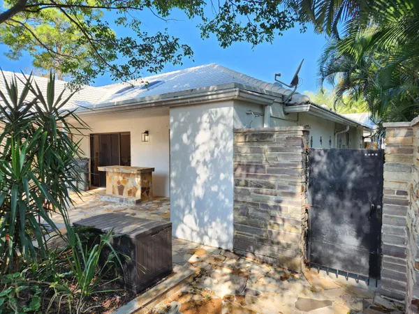 a front view of a house with outdoor seating