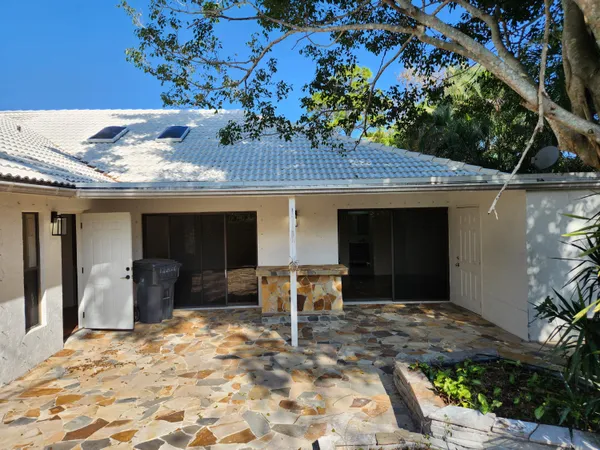 a view of a backyard door and garden
