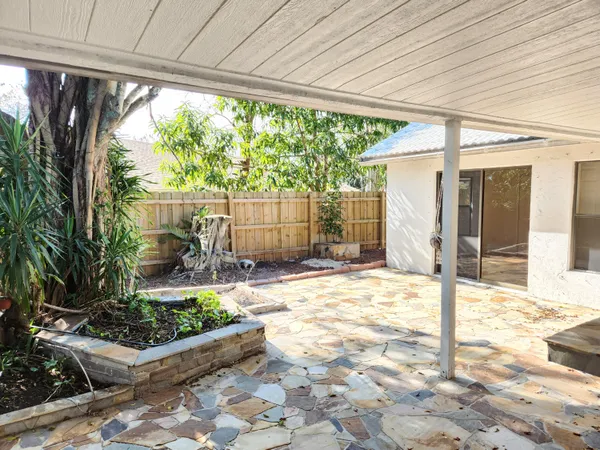 a view of a porch with wooden floor