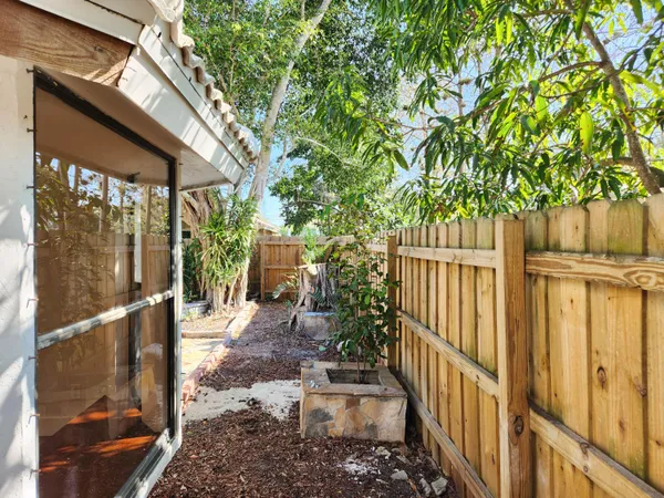 a view of outdoor space with a door and wooden bench