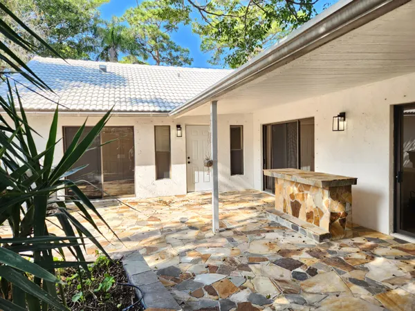 a backyard of a house with table and chairs