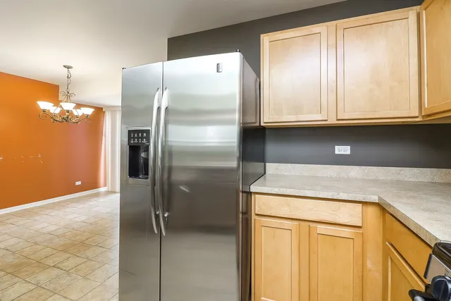 a kitchen with a refrigerator a sink and cabinets