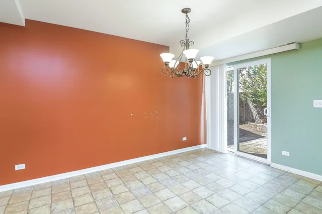 a view of a livingroom with a chandelier fan and windows