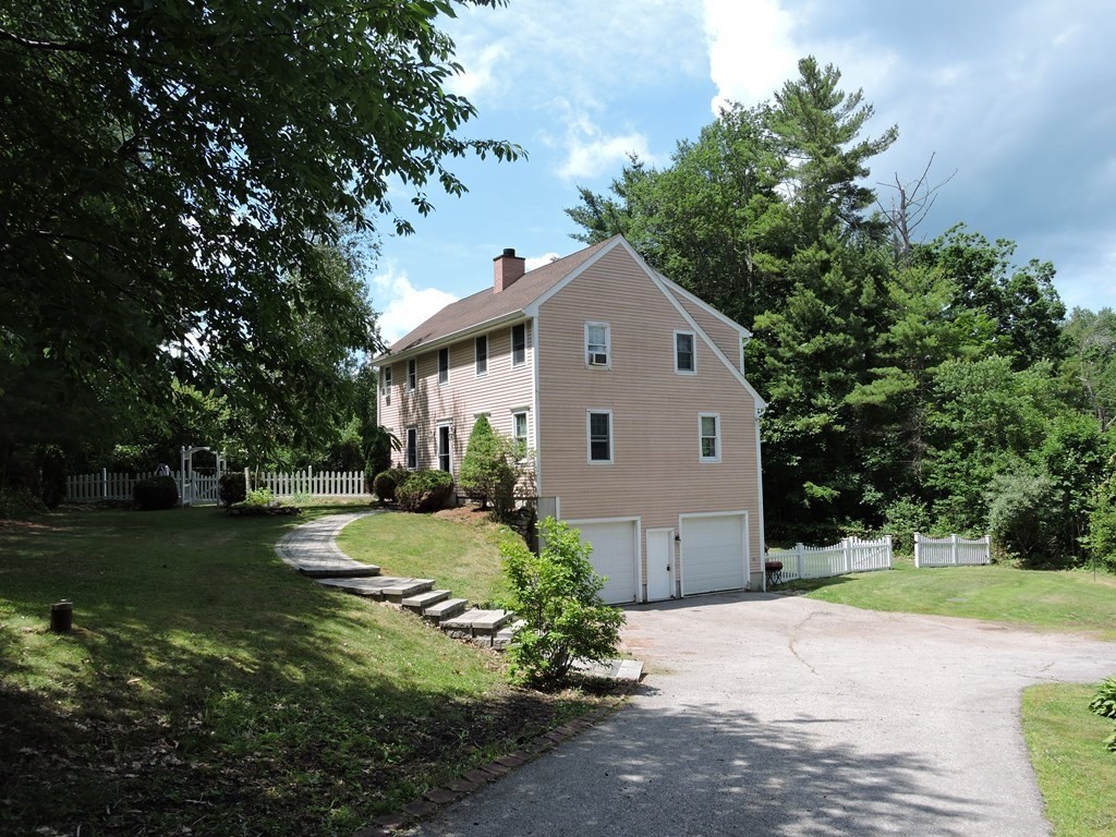 120 North Sturbridge Road Charlton, MA 01507 - Photo 1 of 39 a view of a white house with a yard plants and large tree