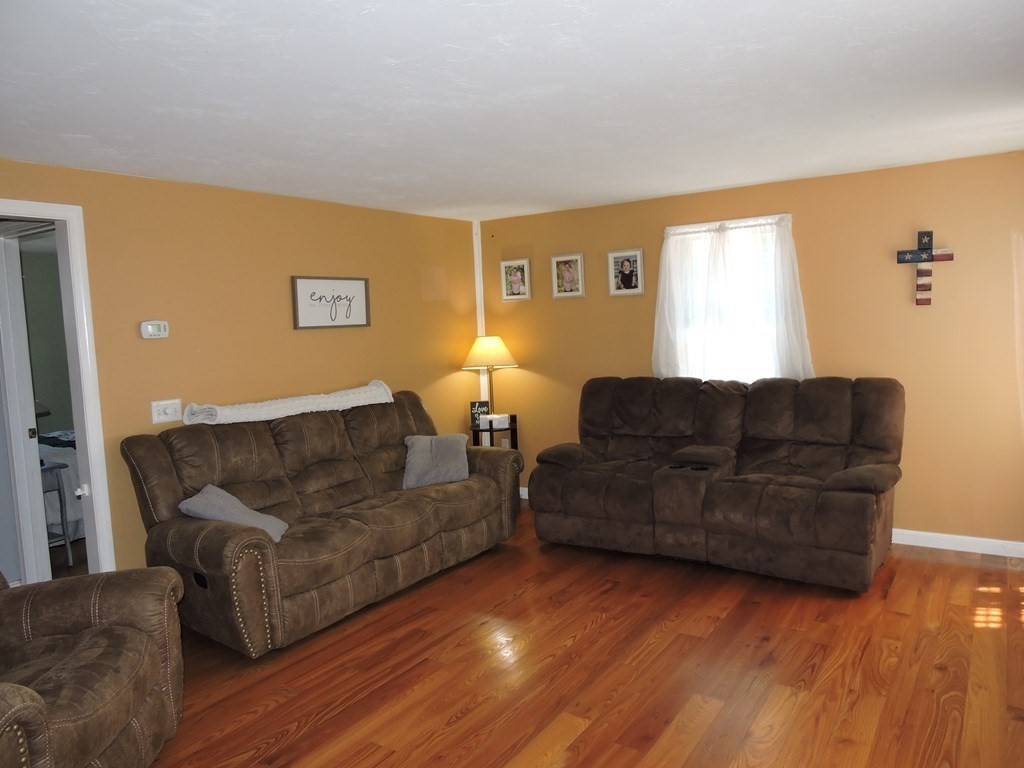 120 North Sturbridge Road Charlton, MA 01507 - Photo 6 of 39 a living room with couches and a flat screen tv with wooden floor