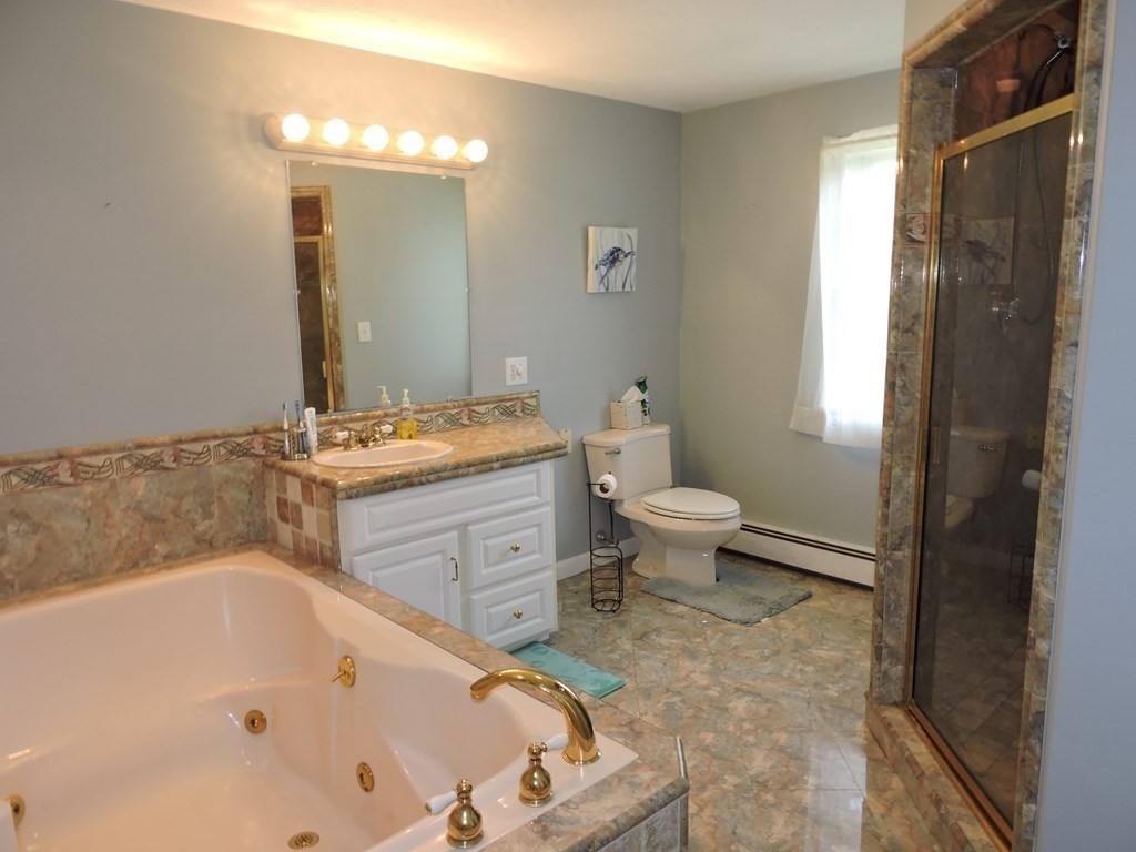120 North Sturbridge Road Charlton, MA 01507 - Photo 8 of 39 a bathroom with a bathtub sink mirror and toilet