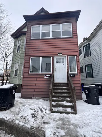 a front view of a house with stairs