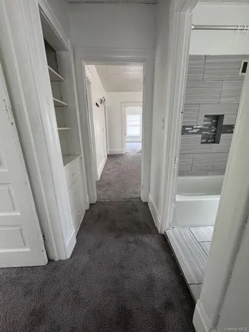 a view of a hallway with wooden floor and entryway