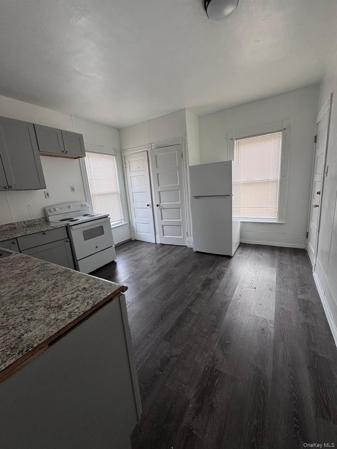 362 Church Street, Unit #2 Poughkeepsie, NY 12601 - Photo 15 of 18 a kitchen with granite countertop wooden floors and wide window