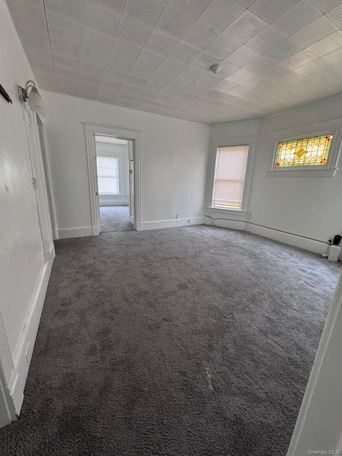 362 Church Street, Unit #2 Poughkeepsie, NY 12601 - Photo 17 of 18 an empty room with windows and mirror