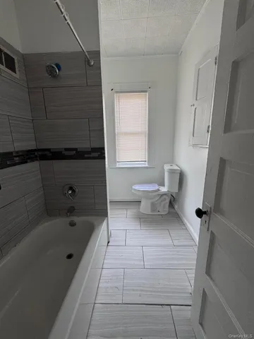 a bathroom with a bathtub and toilet
