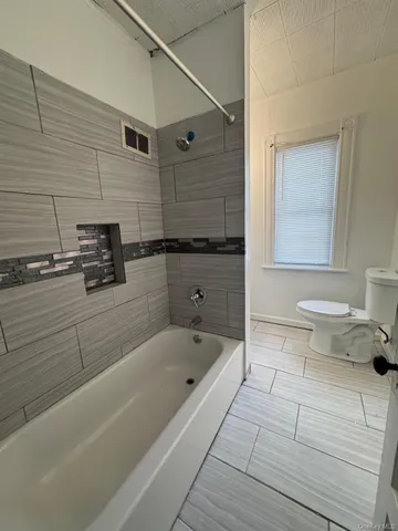 a bathroom with a bathtub and a sink