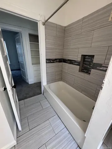 a bathroom with a bathtub and a shower