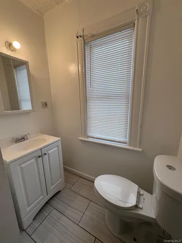 a bathroom with a sink a toilet and vanity