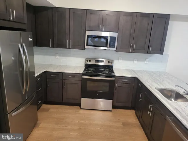a kitchen with a sink stove and microwave