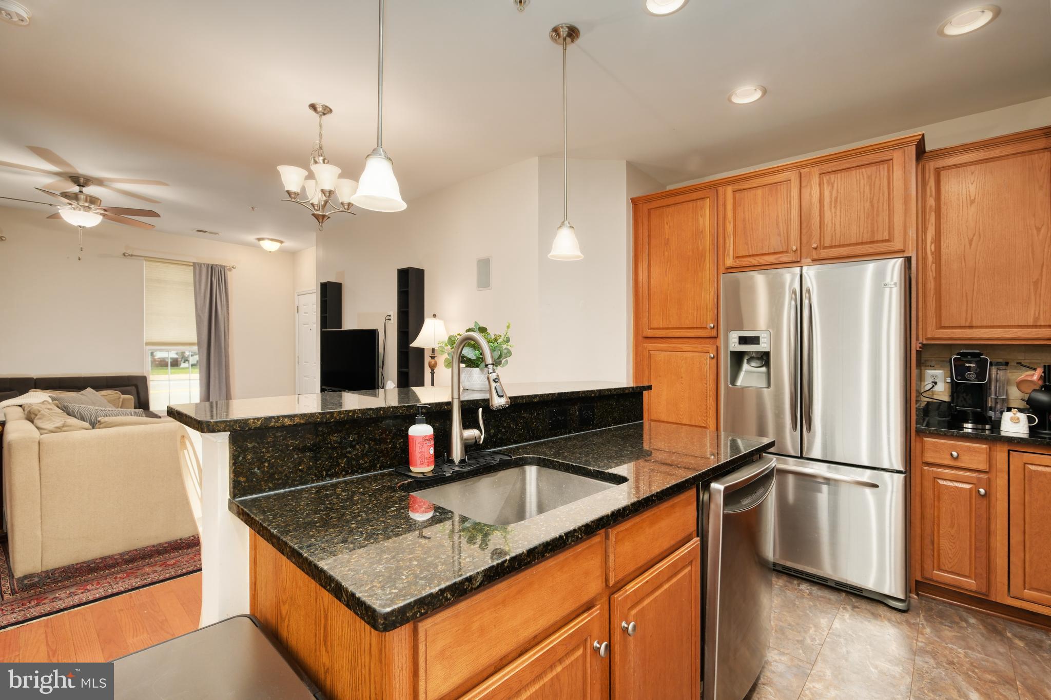 9583 Center Street Manassas, VA 20110 - Photo 17 of 34 Granite-topped island w/pendant lights