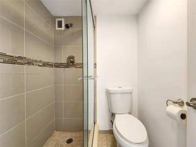 a white toilet sitting next to a bathroom sink
