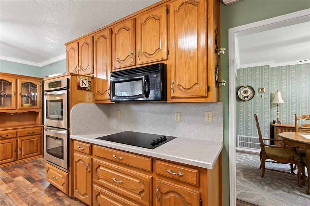 455 Stirrup Ranch Road Trinidad, TX 75163 - Photo 7 of 20 a kitchen with stainless steel appliances granite countertop a stove microwave and cabinets