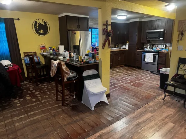 a room with lots of wooden furniture and a view of living room
