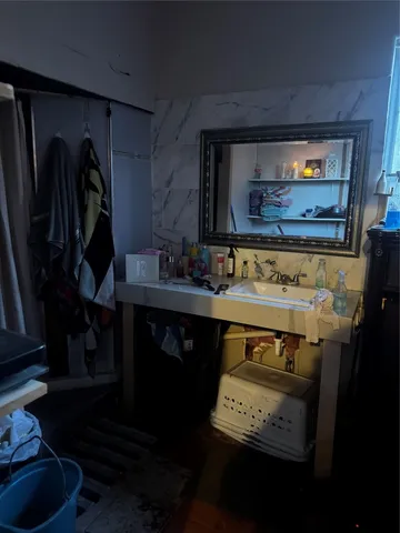 a view of washer and dryer with bathroom in the background