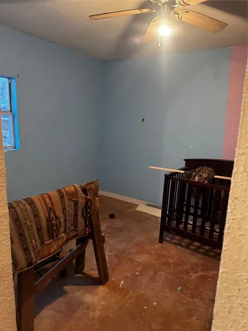 a bedroom with a bed and a night stand